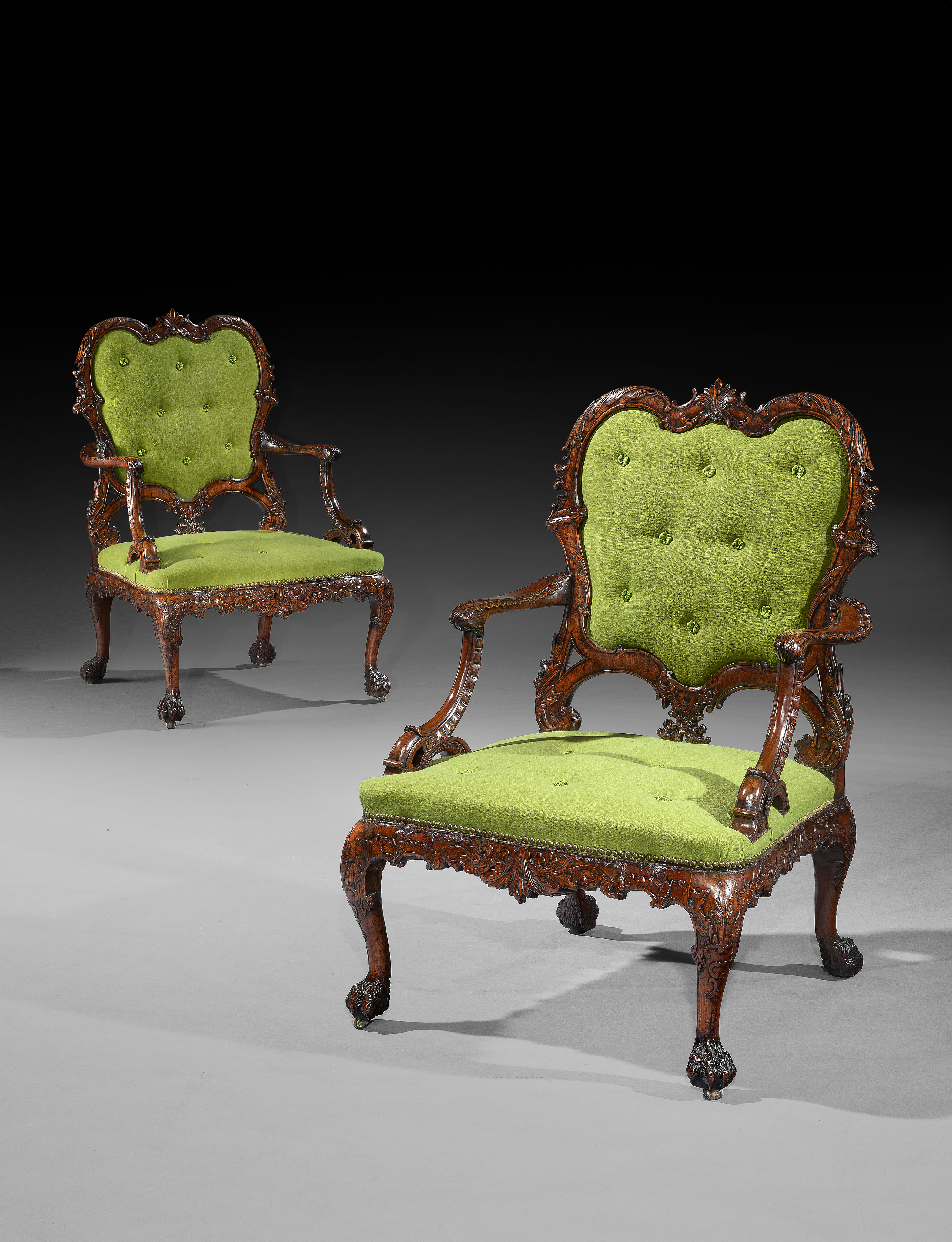 A RARE PAIR OF GEORGE II PERIOD CARVED MAHOGANY ARMCHAIRS AFTER A DESIGN BY THOMAS CHIPPENDALE
